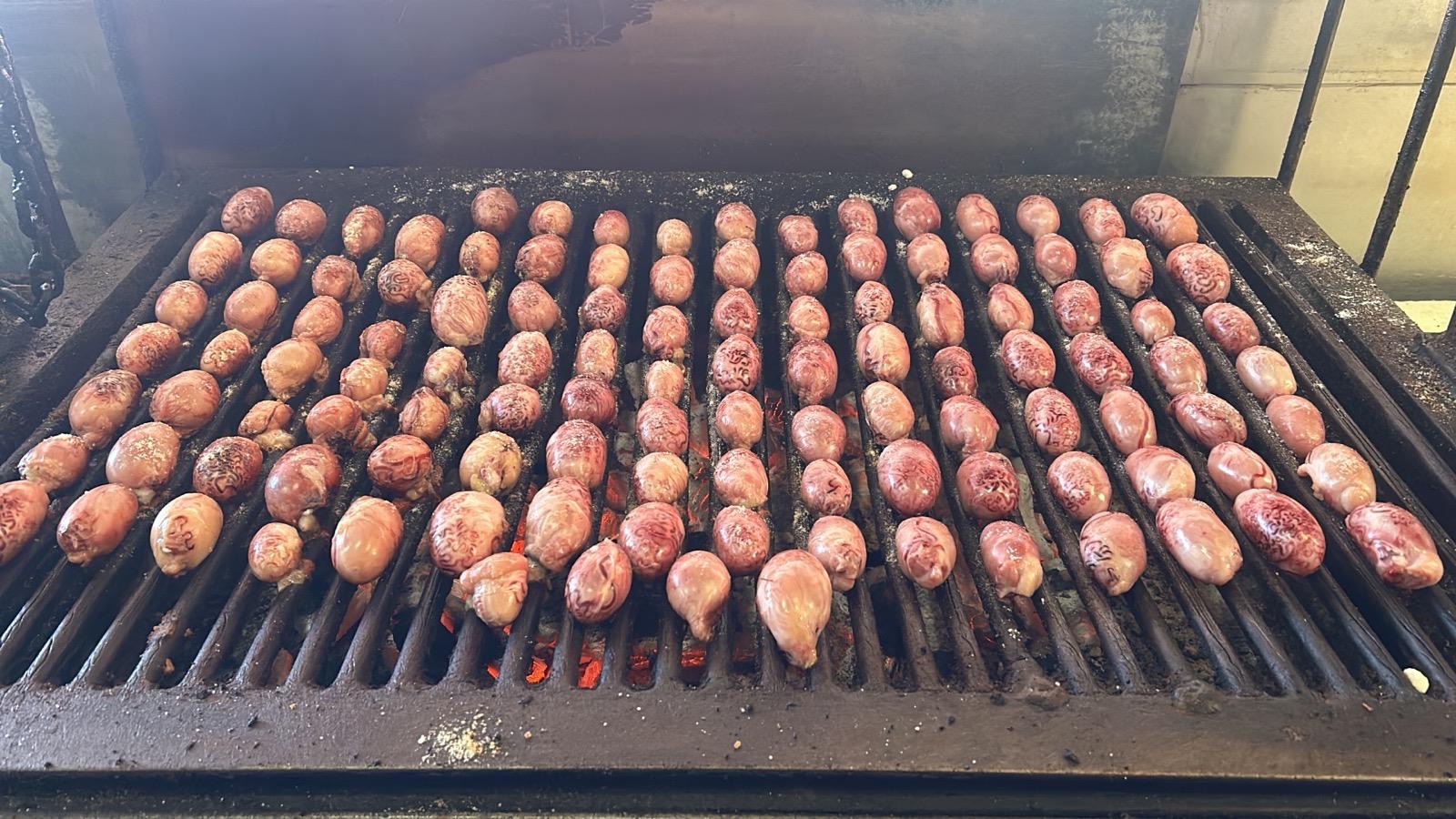 Huevos de toro grilling over mesquite coals