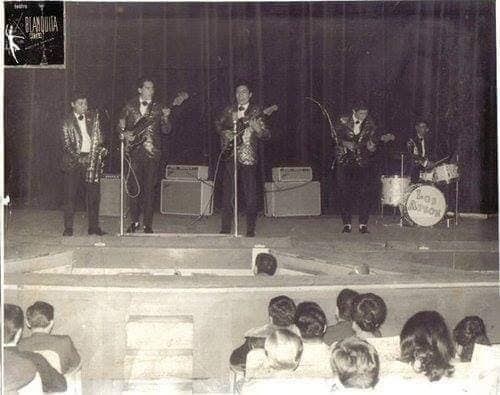 Los Apson performing live on stage to a full theater