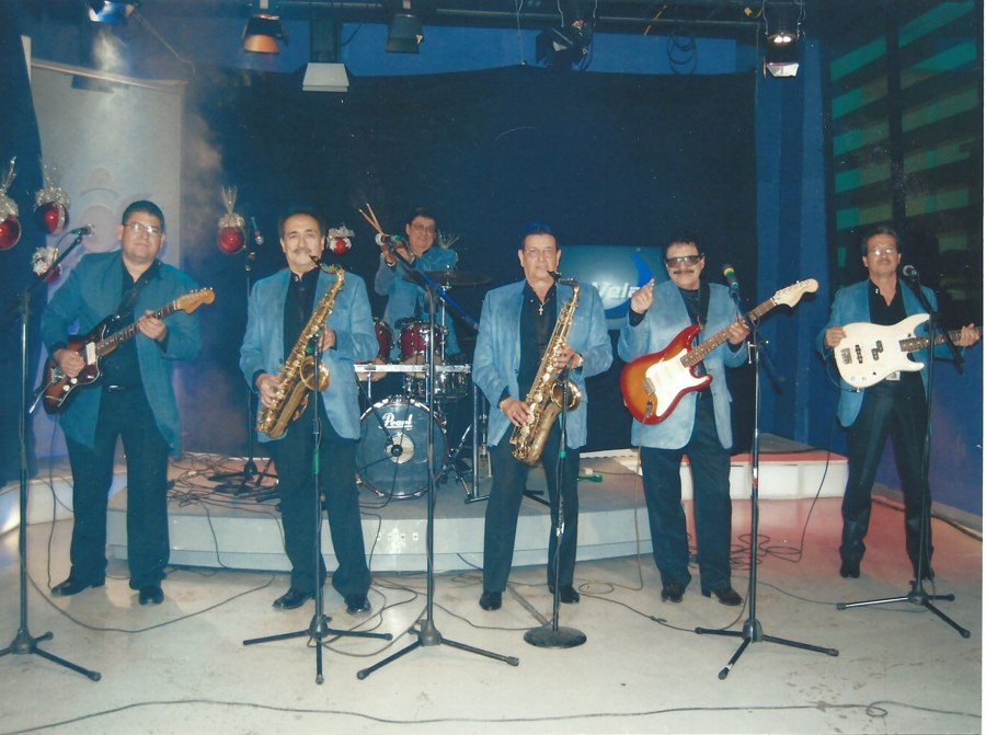Los Apson performing on television, matching blue suits