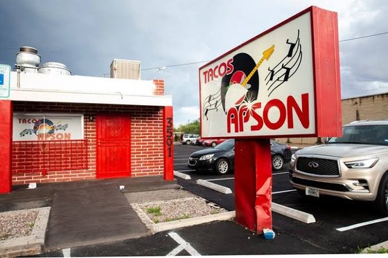 The Tacos Apson mural out front, vinyl record and guitar taco